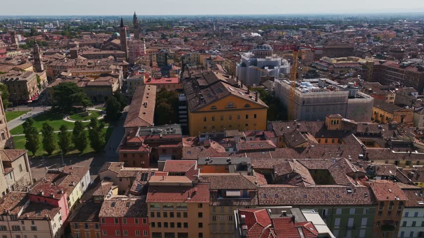 Aerial drone view of Teatro Regio in Parma, Italy, showcasing the historic opera house, neoclassical architecture, elegant façade, and surrounding old town cityscape.
