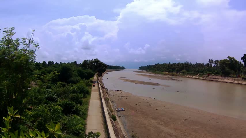 River, tropical forest, clouds. Sunny day.