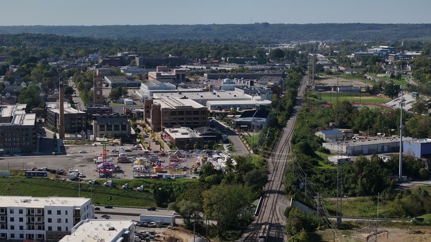 Aerial view of industrial buildings, railway tracks, and urban development in Cincinnati, Ohio, United States.