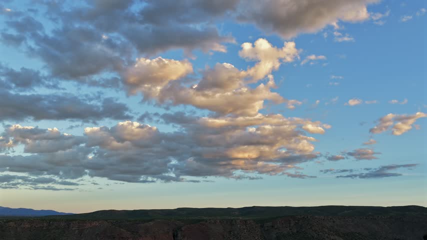 Aerial view of colorful clouds over a high desert landscape during dusk in White Rock, New Mexico, United States.