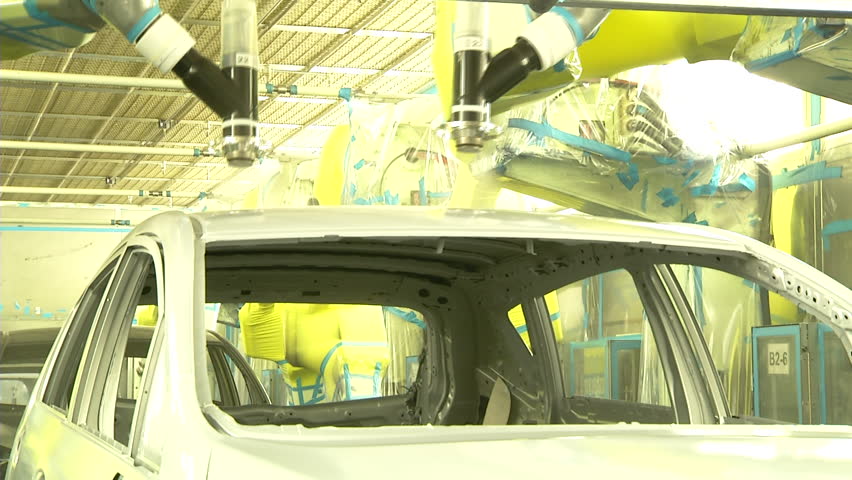 Robots are painting in automobile factory