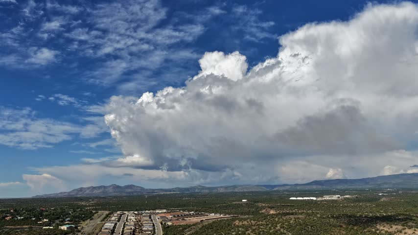Aerial view of clouds and fog shifting above the main road of White Rock, New Mexico, United States.