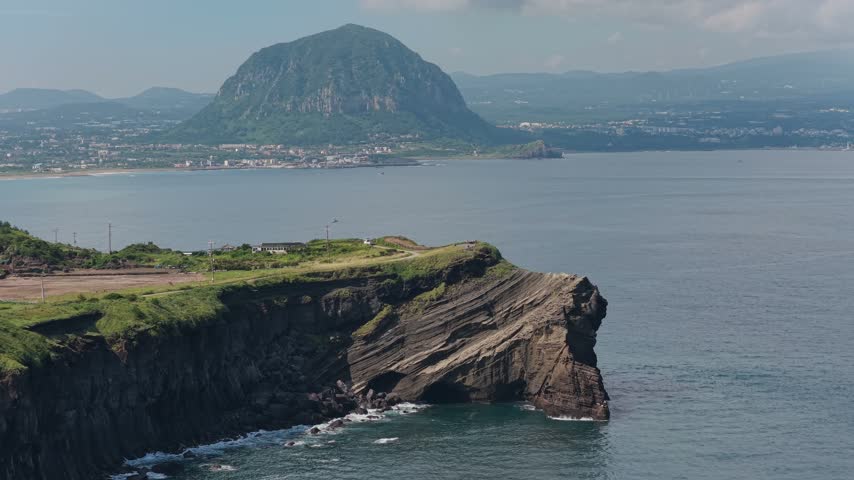 Songaksan Mountain on Jeju Island, South Korea, showing the volcanic mountain landscape, rugged slopes, coastal terrain and surrounding natural scenery