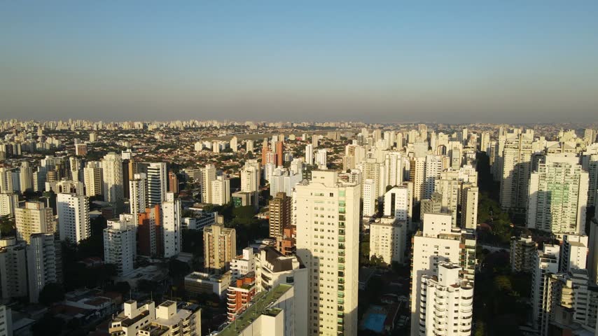 Aerial view of the dense urban skyline of Sao Paulo with numerous high-rise residential buildings under a clear sky in Sao Paulo, Sao Paulo, Brazil.