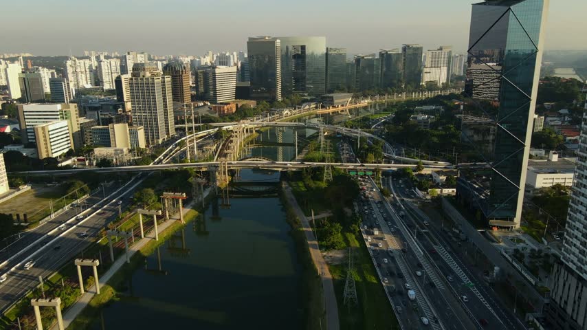 Aerial view of the modern skyline of Sao Paulo with the Pinheiros River and busy highway traffic in Sao Paulo, Sao Paulo, Brazil.