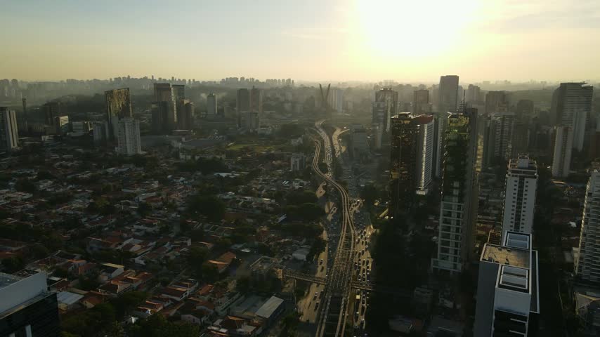 Aerial view of the iconic Octavio Frias de Oliveira cable-stayed bridge spanning the Pinheiros River amidst the dense urban skyline of Sao Paulo, Sao Paulo, Brazil.