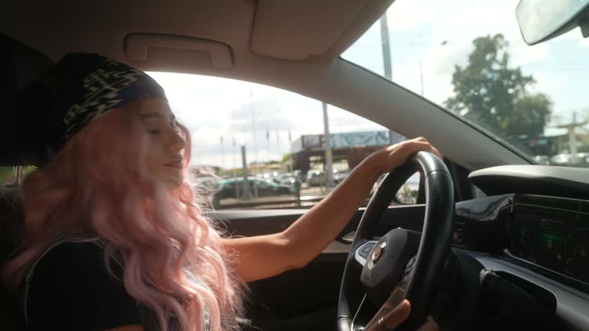 Woman turning toward the passenger camera while driving