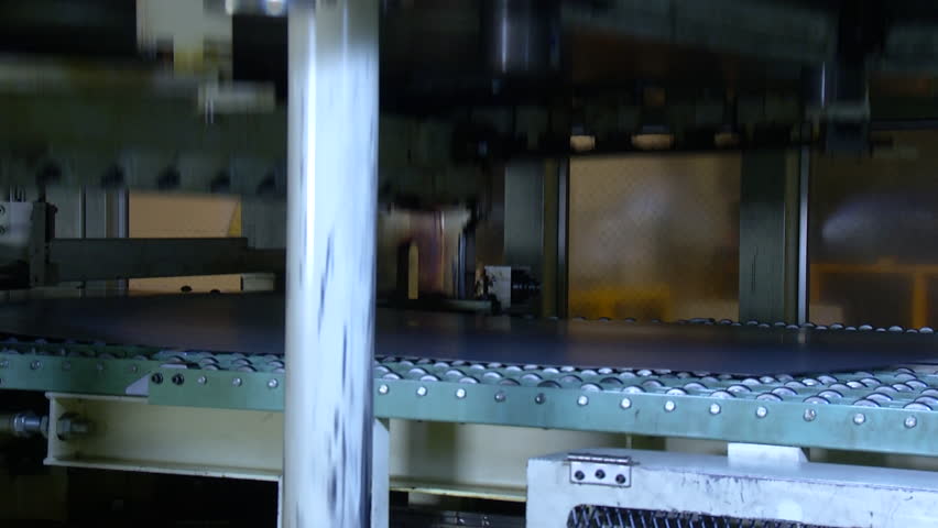 Machine is cutting sheet metal in automobile factory