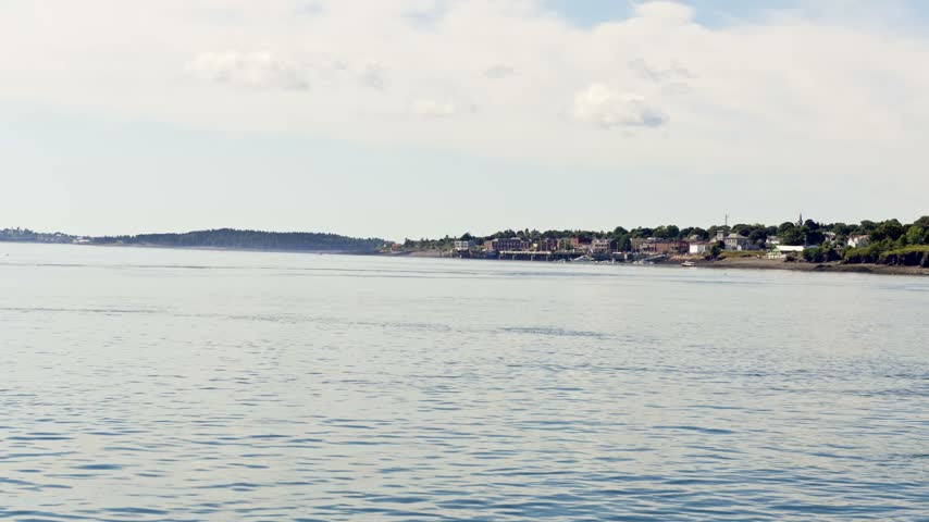 Scenic video across the open waters of Passamaquoddy Bay looking toward the historic coastal town skyline of Eastport, Maine.