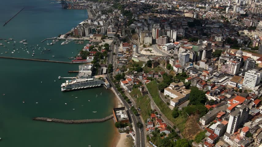 Aerial view of the coastal city of Salvador with its harbor, cruise ship, and dense urban architecture along the coastline in Salvador, Bahia, Brazil.