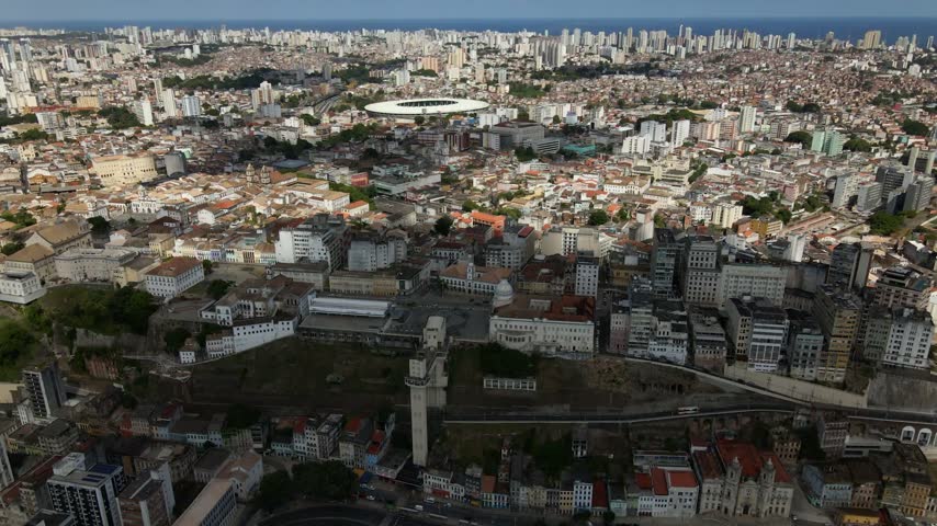 Aerial view of the historic center of Salvador, featuring the iconic Elevador Lacerda, dense urban architecture, and the surrounding cityscape in Salvador, Bahia, Brazil.