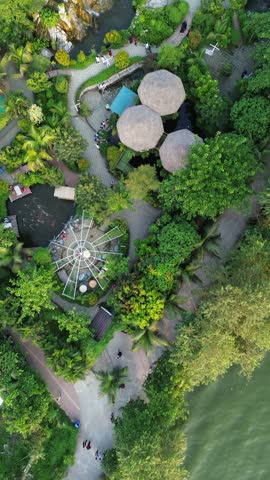 Aerial view of a landscaped park with a pond and waterfall vertical drone shot of beautifully featuring scenic pond