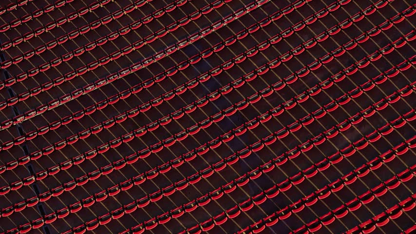 Aerial view of red stadium seats at LA Memorial Coliseum in Los Angeles, California, United States.