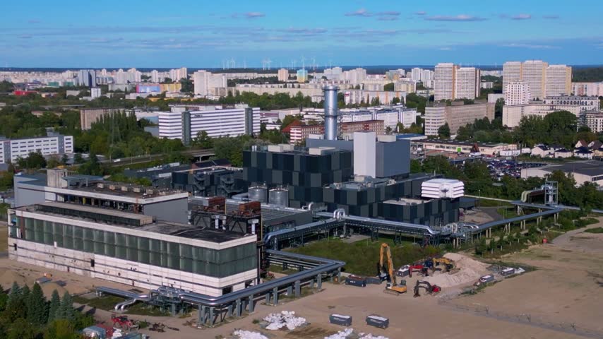 Marzahn Combined Cycle Power Plant producing electricity for urban residential areas in Berlin, Germany. Wind turbines visible in the background. Fabulous aerial view