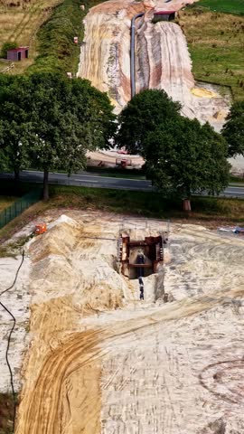 Aerial view of pipeline construction site with trenching and sandy soil in Konin, Wielkopolskie, Poland.