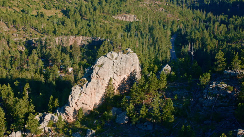Cinematic drone shot of unique rock formations across the rugged landscape of the Black Hills in South Dakota.