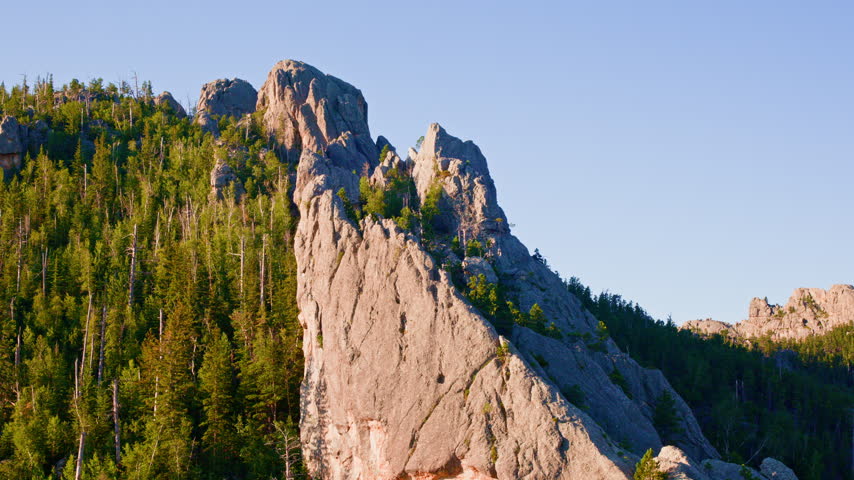 Aerial drone footage showcasing striking rock formations in the wild terrain of South Dakota’s Black Hills.