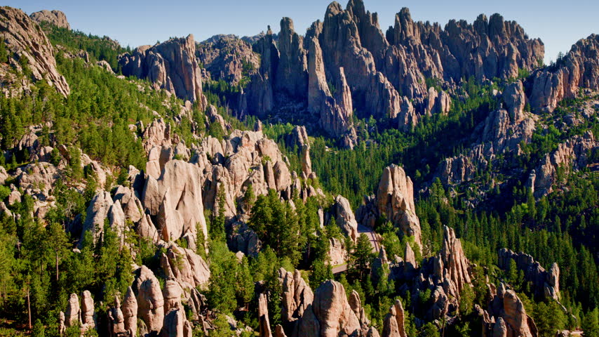 Aerial footage capturing the rugged beauty and striking rock formations of the Black Hills in South Dakota.