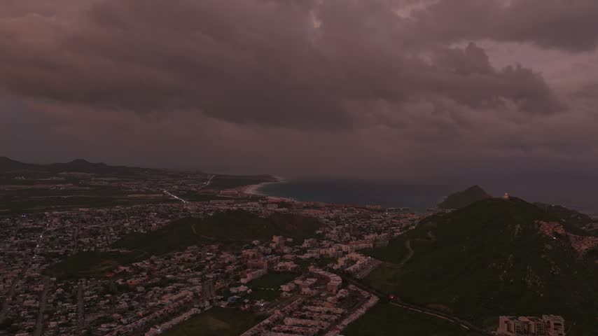 Wide aerial panorama of a dark overcast sky with severe hurricane clouds approaching Cabo San Lucas, Los Cabos, Baja California Sur, Mexico.