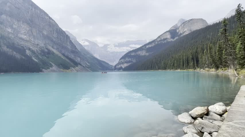 Calm turquoise Lake Louise with mountain reflections, Banff National Park, Alberta, Canada