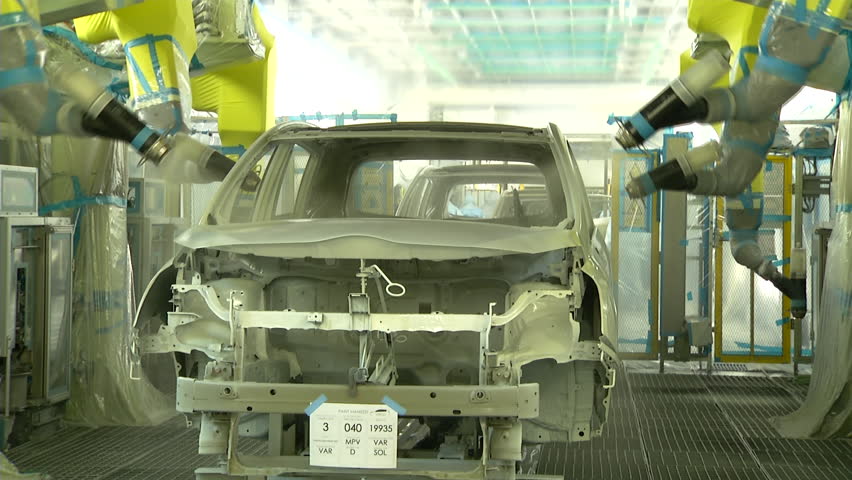 Robots are painting automobile in factory