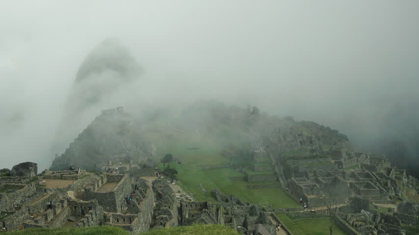 Atmospheric view of Machu Picchu emerging through mist and clouds in the Andes Mountains of Peru