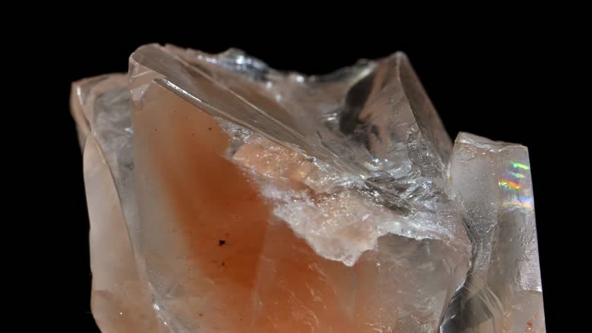 Orange Calcite crystal sample rotating slowly