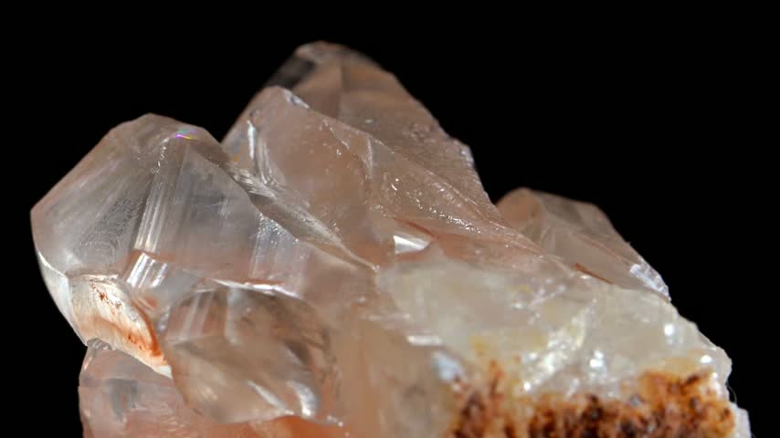 Orange Calcite crystal sample rotating slowly