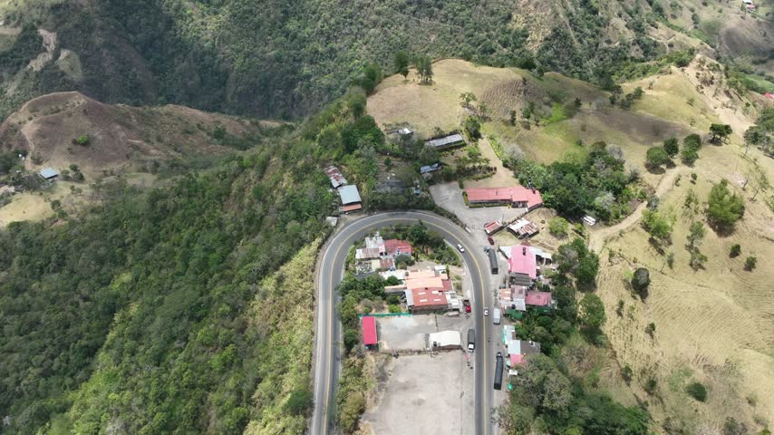 Mountain road with trucks and transport infrastructure on the highland corridor between Bogota and Honda, Colombia. Aerial view.
