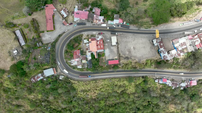 Mountain road with trucks and transport infrastructure on the highland corridor between Bogota and Honda, Colombia. Aerial view.