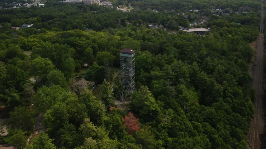 Drone orbiting around fire tower above rooftops in Port Perry, Durham Region, Ontario