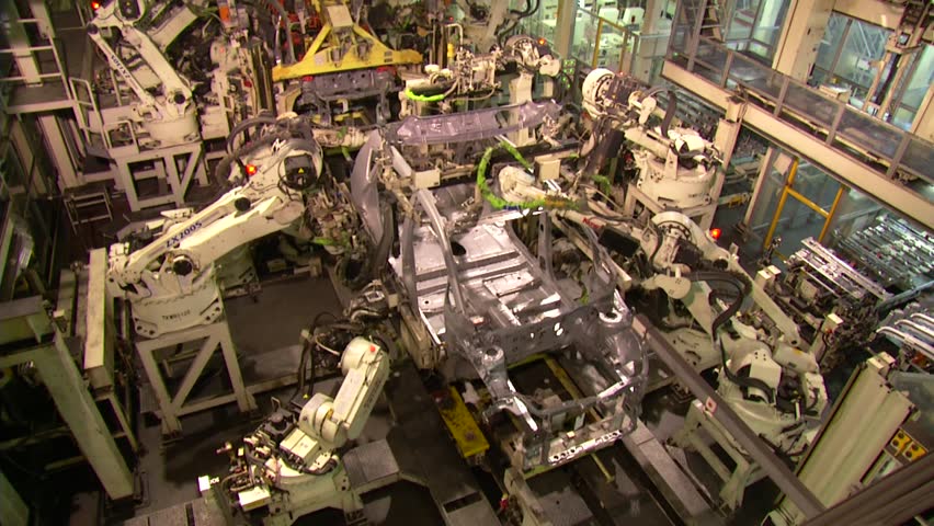 Robots are welding in automobile factory. assemble a car in fast motion. 