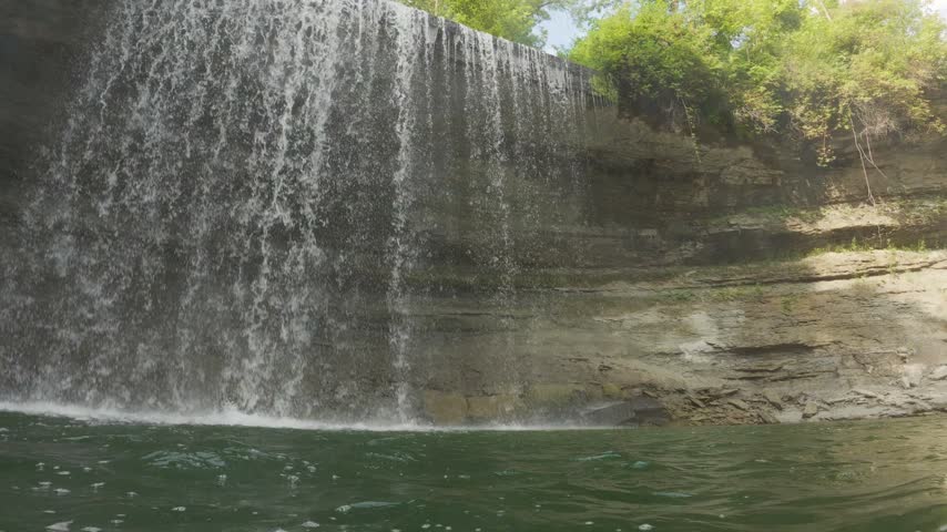 Water cascading over Niagara Escarpment limestone ledge at Bridal Veil Falls, Ontario, Canada
