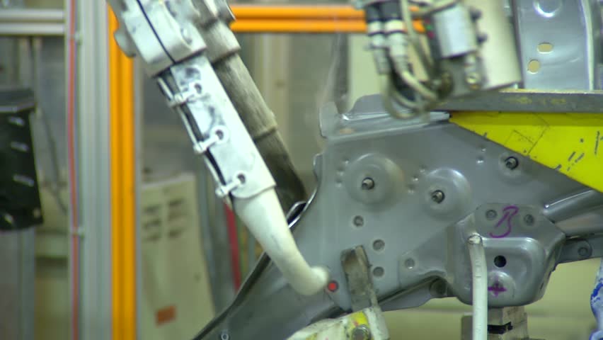 Robots are welding in automobile factory