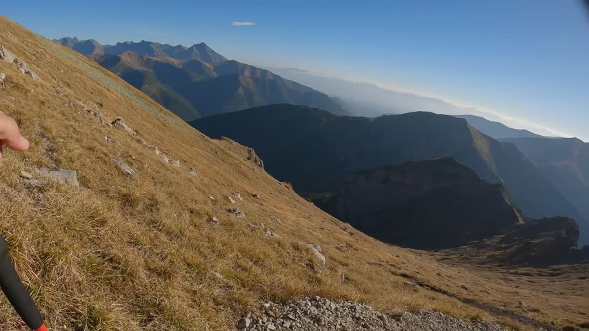 Rugged stone path traverses open grassland on the Czerwone Wierchy ridge