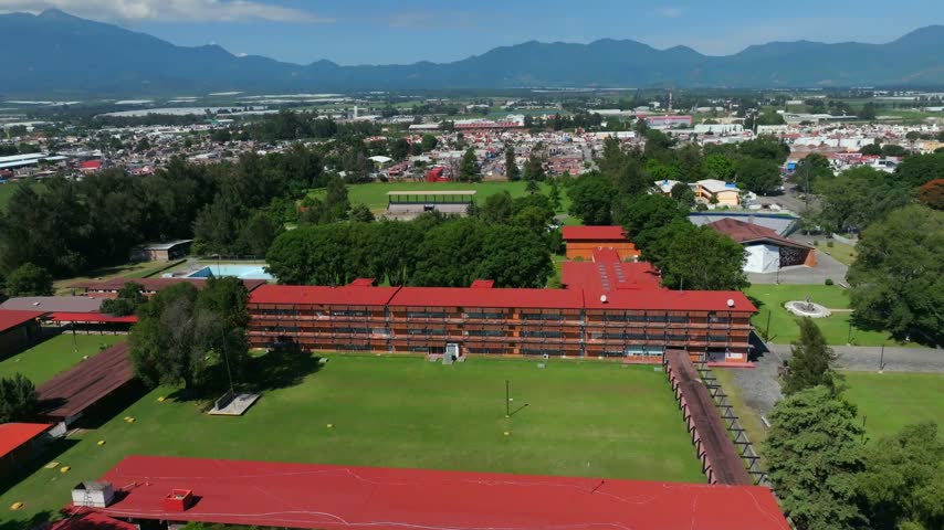 School Buildings, Courtyard Lawns, And Surrounding Town Landscape Of Centro Regional de Educacion In Ciudad Guzman, Jalisco, Mexico - aerial shot