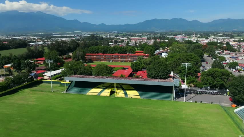 Soccer Pitch, Grandstand Bleachers, And Campus Buildings At Centro Regional De Educacion In Ciudad Guzmán, Jalisco, Mexico. - aerial shot