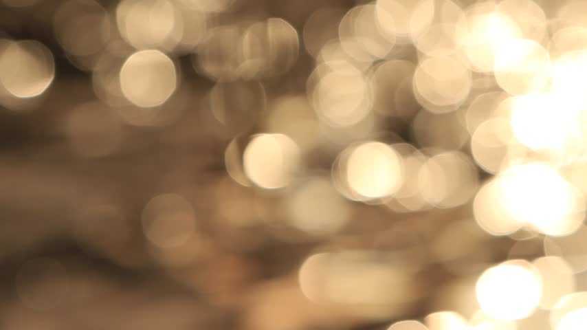 Sunlight glinting on the surface of a fast-flowing river.