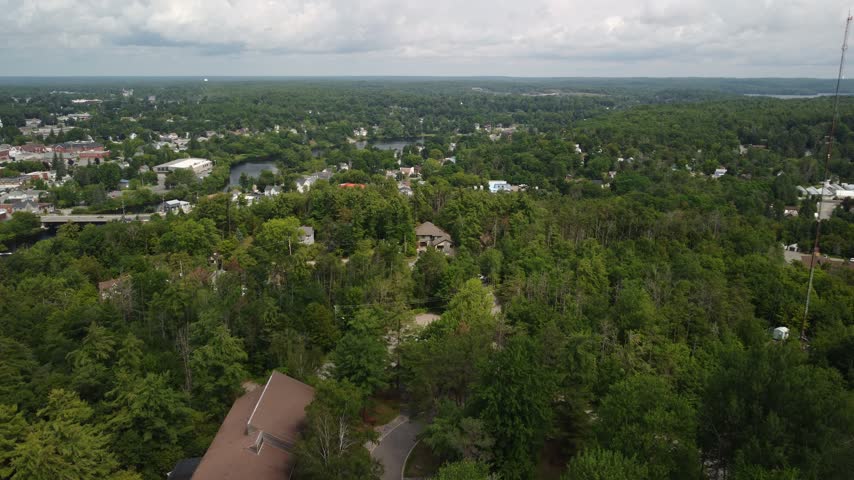 Aerial establishing shot of fire tower landmark in Port Perry, Scugog Township, Ontario, Canada