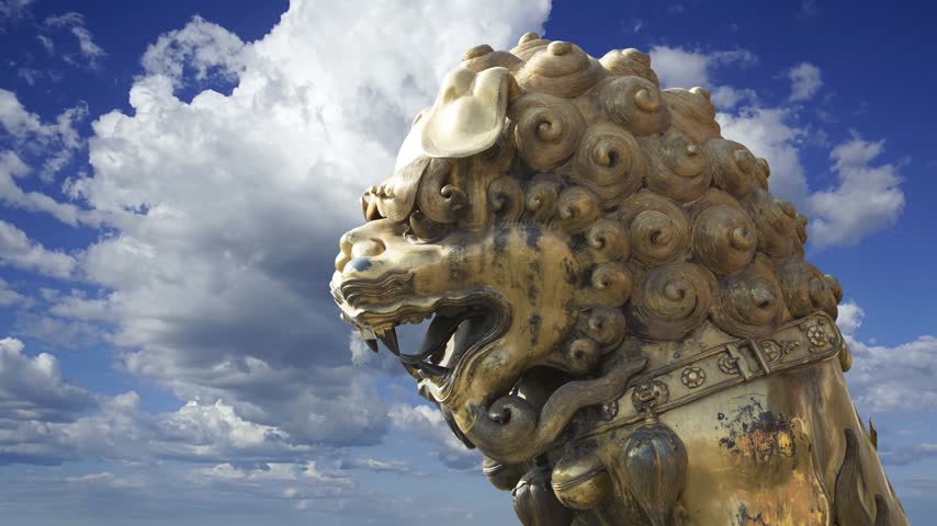 A bronze Chinese dragon statue (against the sky with clouds) in the Forbidden City. Beijing, China. 4K, time lapse