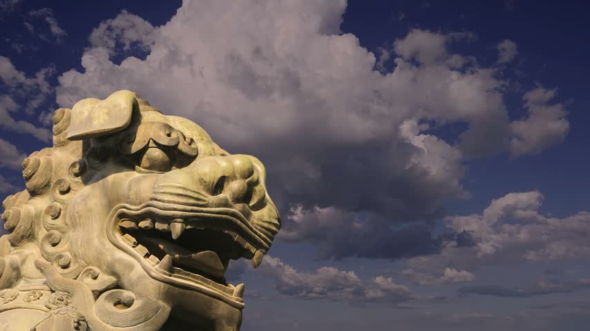 A bronze Chinese dragon statue (against the sky with clouds) in the Forbidden City. Beijing, China. 4K, time lapse
