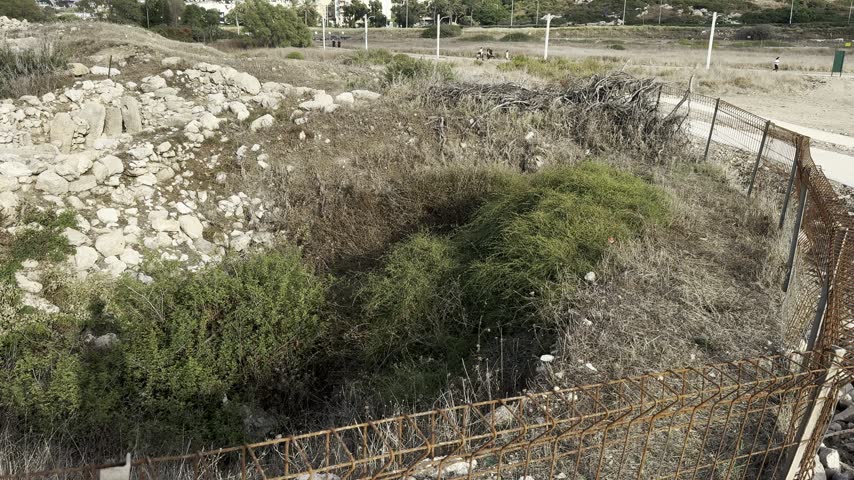Ancient stone ruins of Tel Shikmona archaeological site on the rocky Mediterranean coast in Haifa, Israel, revealing remains of a historic settlement dating back to the Bronze Age.