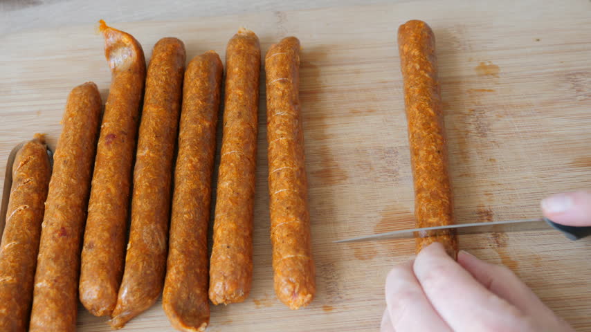 Preparing barbecue sausages on the grill. Picnic food.