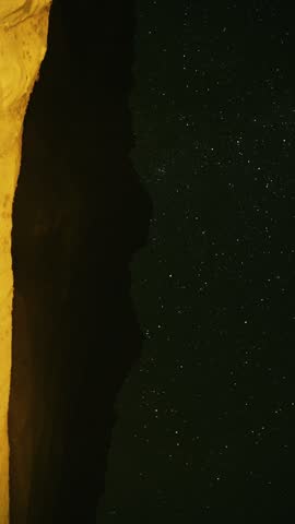 Astrophotography of a Starry Night Sky Over a Mountain Ridge Silhouette