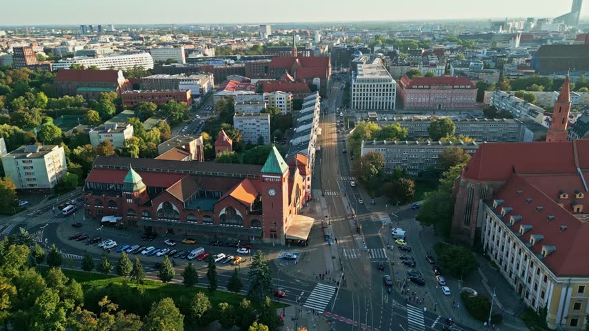 Poland, Wroclaw 2023 09 27: High aerial view of Wroclaw cityscape featuring historic market hall, streets, cars, and surrounding architecture in horizontal landscape perspective.