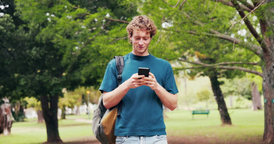 Man, walk and outdoor at university with phone, browsing online and email notification for education. Happy, student and journey in park with tech, college portal and website for learning platform.