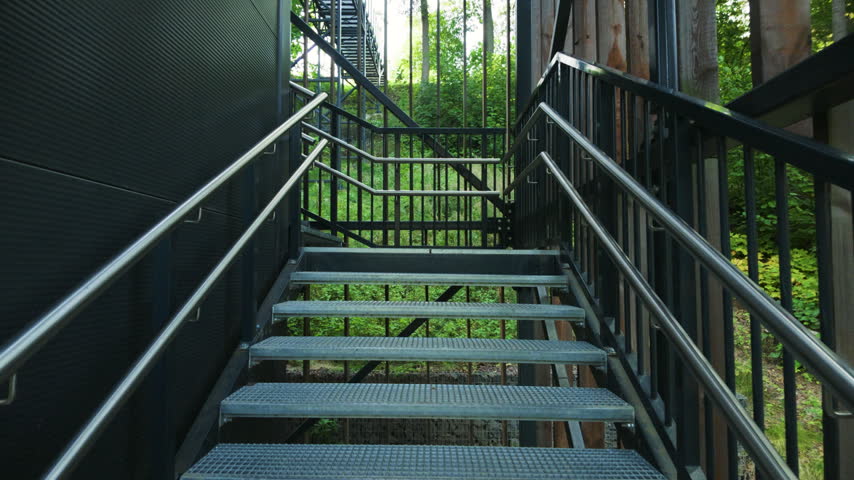 Walking up outdoor metal staircase in a green park