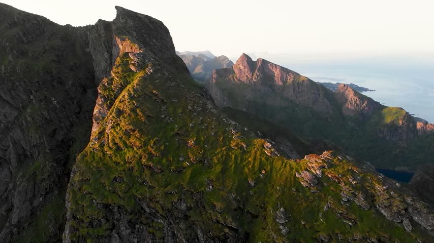 A stunning aerial shot of rugged mountains at sunrise, showcasing natural beauty