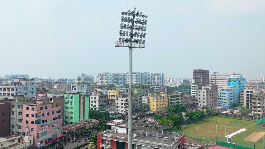 Stadium Floodlight Tower Overlooking Urban City Skyline