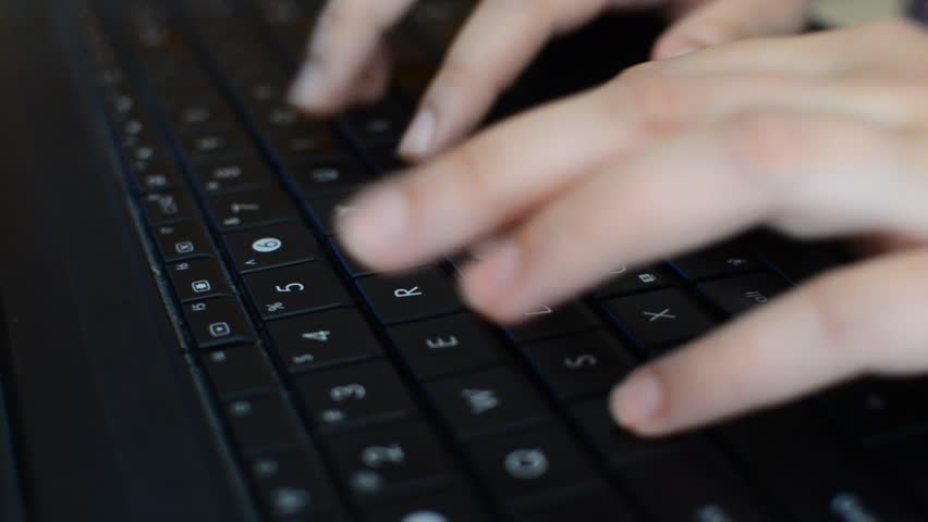Typing on a Keyboard - Dolly Shot, Female hands typing on a laptop`s keyboard,